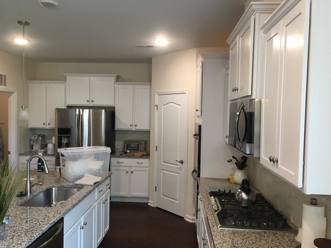 Superior Painting Pros & Wall Covering, Co. finishes cabinets in Lowell